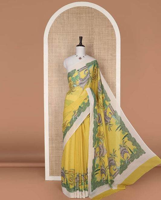 Yellow georgette saree with contrast forest theme design border