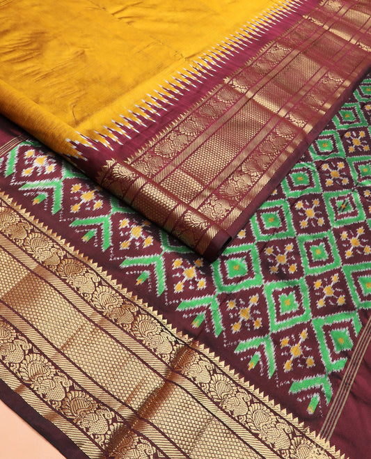 Mustard Plain Ikkat Silk Saree, Complemented by a Contrast Temple Traditional Zari Motif Woven Border, Pallu Adorned with Vibrant Jaal Design, and Paired with a Multi-Coloured Blouse