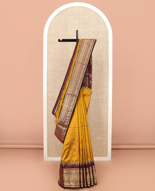 Mustard Plain Ikkat Silk Saree, Complemented by a Contrast Temple Traditional Zari Motif Woven Border, Pallu Adorned with Vibrant Jaal Design, and Paired with a Multi-Coloured Blouse