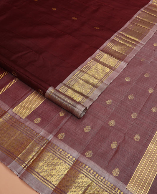Maroon zari buttas Kanchipuram silk saree, contrast one-sided border of paneer sombu, banaras, and jaal designs, and zari design pallu