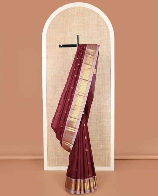 Maroon zari buttas Kanchipuram silk saree, contrast one-sided border of paneer sombu, banaras, and jaal designs, and zari design pallu