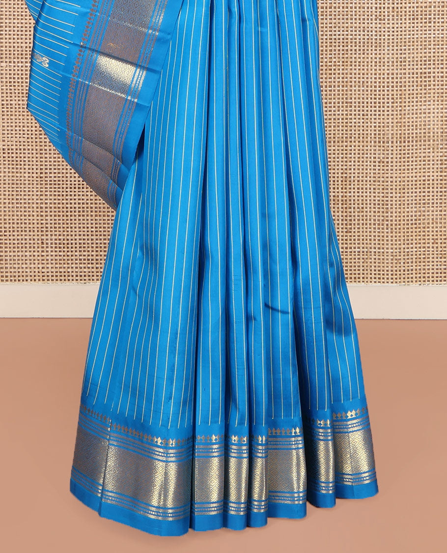 Blue Kanchipuram Silk Saree, Beautified with Zari Buttas and Stripes on Its Body, Highlighted by a Zari One-Sided Border of Panner Sombu, Banaras, and Jaal Designs, Pallu Features Zari Designs, and Comes Without a Blouse