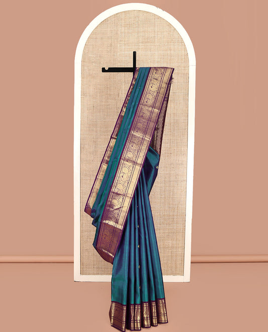 Blue Kanchipuram Silk Saree, Features Zari Buttas All Over Its Body, Complemented by a Contrast Border of Mayil Kann, Mayil, and Jaal Designs, Grand Jaal Pallu, and Paired with a Contrast Blouse