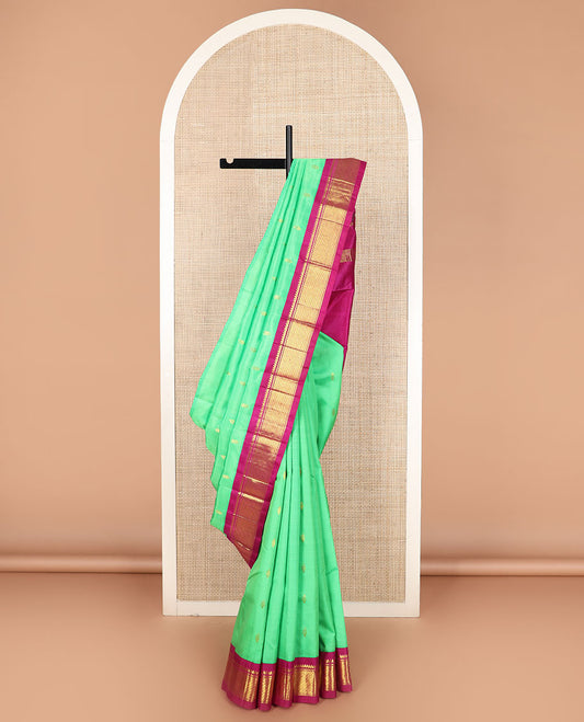 Green zari buttas Kanchipuram silk saree, contrast korvai border of thilakam mokku, banaras, and puli nagam designs, and zari design pallu