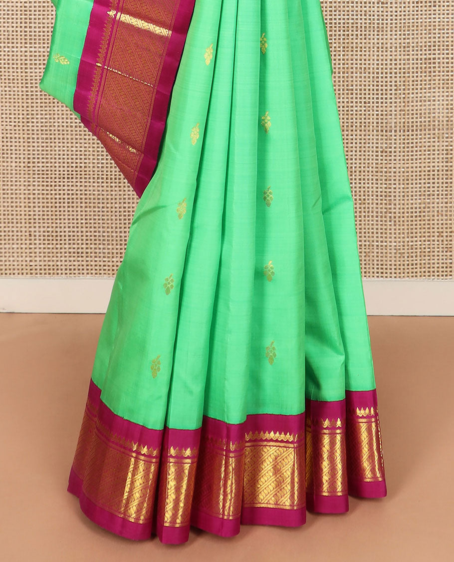 Green zari buttas Kanchipuram silk saree, contrast korvai border of thilakam mokku, banaras, and puli nagam designs, and zari design pallu