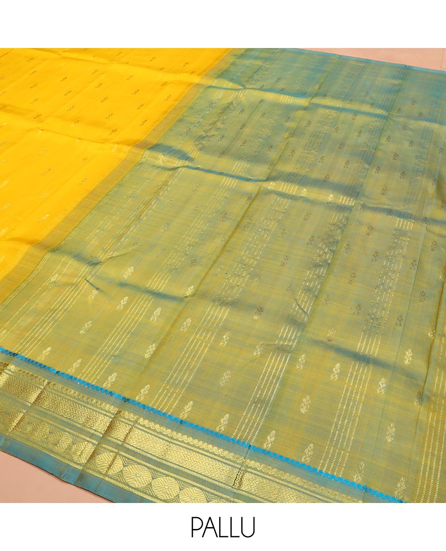 Yellow Kanchipuram Silk Saree Subtly Sparkled with Zari Buttas All Over Its Body, Complemented by a Contrast One-Sided Border of Thilakam Mokku, Banaras, Vanki, and Rudraksham Designs, Pallu of Zari Motifs, and Comes Without a Blouse