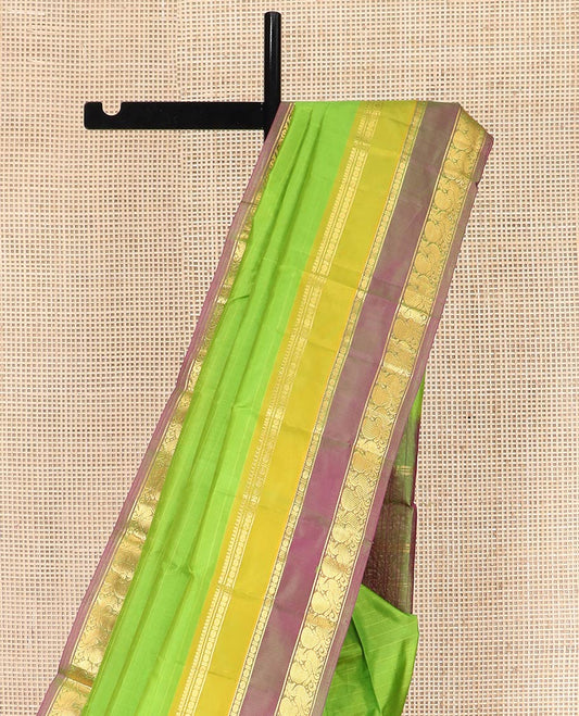 Green Kanchipuram Silk Saree Adorned with Vazhaipoo Stripes, Complemented by Contrast Rettai Pettu Border of Thilakam Mokku, Rudraksham, and Mayil Designs, Zari Woven Pallu, and Paired with a Contrast Blouse