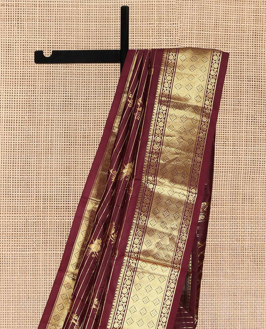 Maroon Kanchipuram Silk Saree, Gleamed Up with Zari Stripes and Bird Buttas on Its Body, Highlighted by a One-Sided Border of Kodi Visiry, and Jaal Designs, Pallu of Geometric Designs, and Comes Without a Blouse