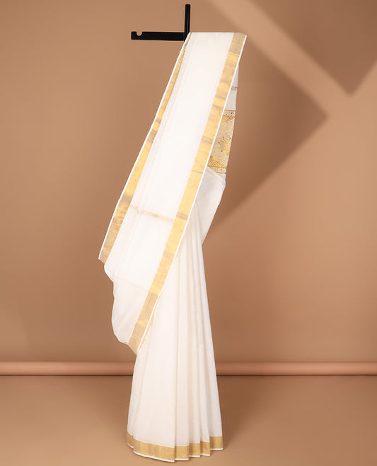 Cream kerala saree with zari buttas, plain border & pallu of intricate zari designs