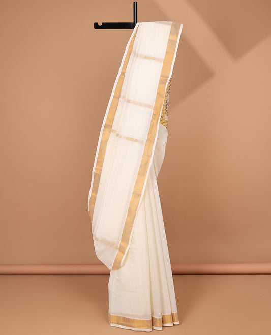 Cream kerala saree with zari stripes, zari border & pallu of floral designs