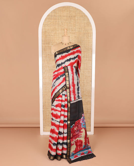 Red shibori printed muslin cotton saree, contrast peacock zari border, village scenery printed pallu, and a contrast polka dotted zari border blouse