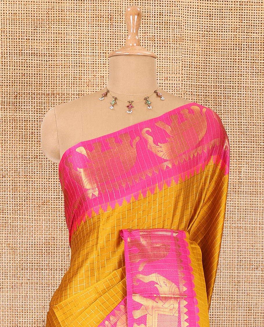 Mustard zari checked semi-taffeta saree, contrast satin temple border of elephant motifs, striped pallu, and a contrast striped blouse