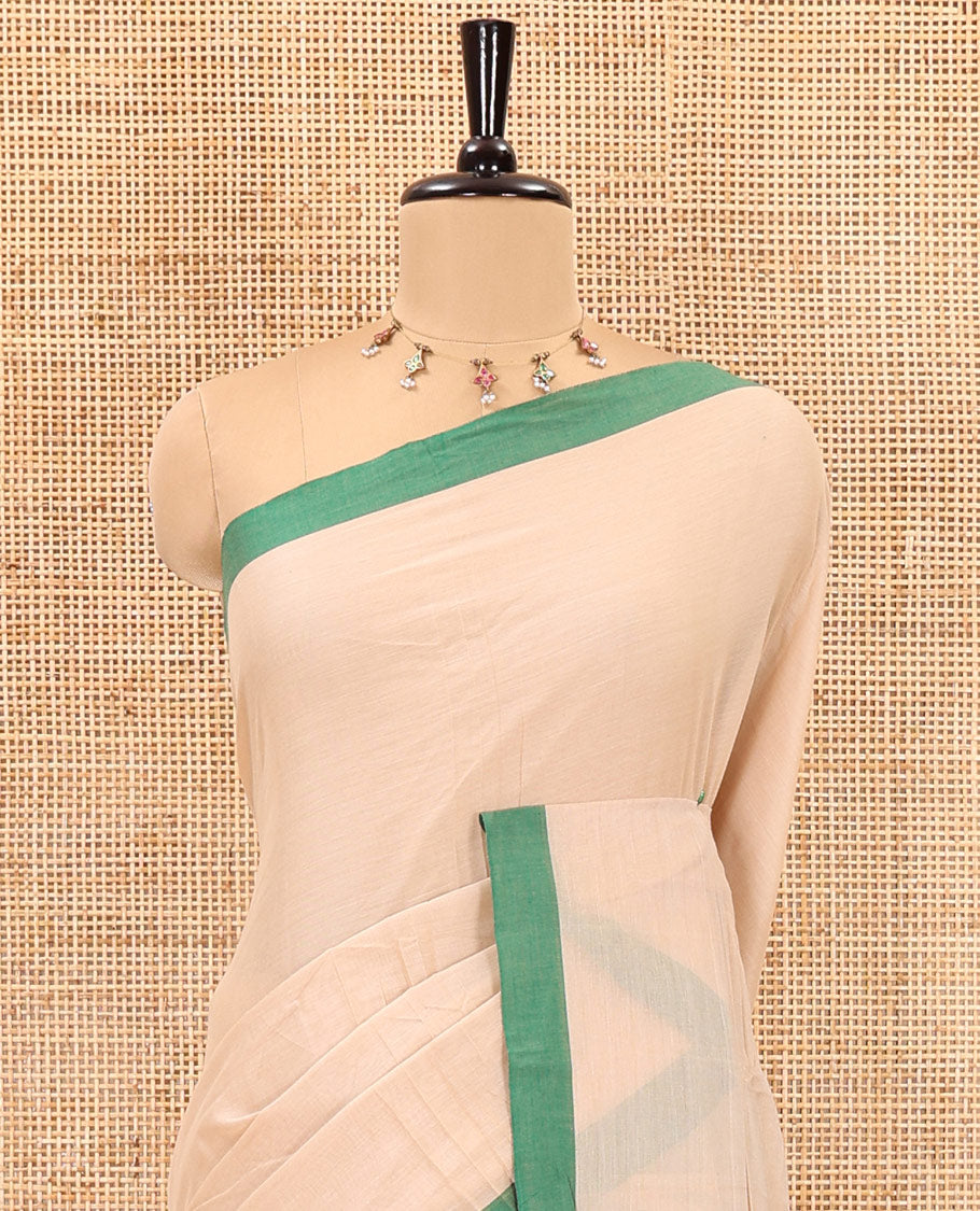 Cream-green plain mercerised cotton saree,contrast plain  border, striped pallu, and a contrast plain blouse