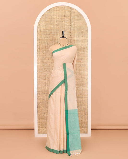 Cream-green plain mercerised cotton saree,contrast plain  border, striped pallu, and a contrast plain blouse