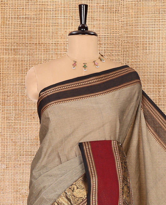 Beige plain Chettinad cotton saree, contrast rettai pettu peacock motifs border, striped pallu, and a matching blouse