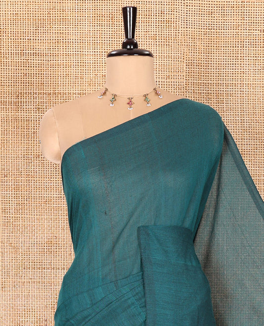 Borderless Peacock Color Plain Khadi Mul Cotton Saree Features a Self-Pallu with Tassels, and a Matching Blouse