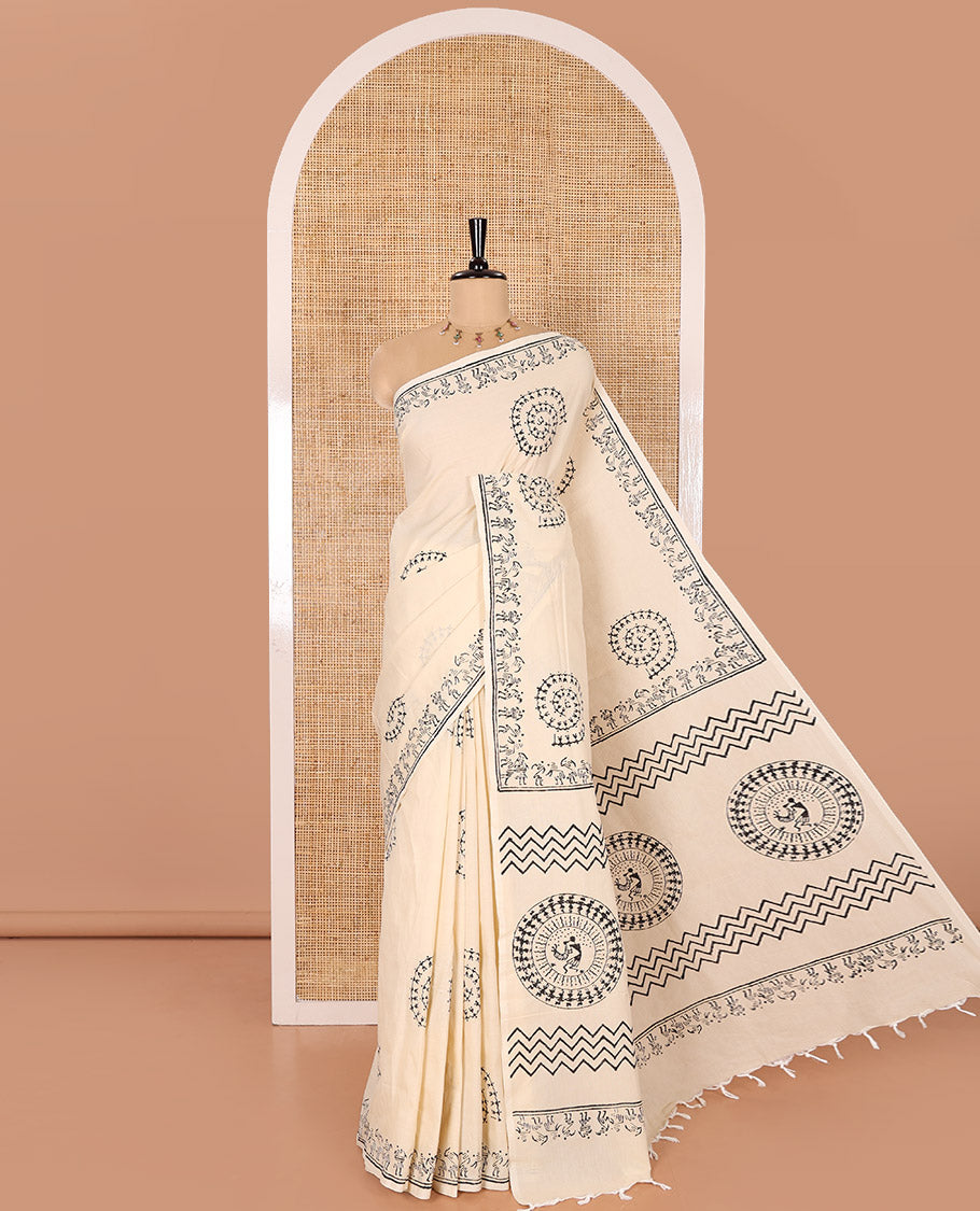 Cream South Cotton Saree Featuring Warli-Village Theme Printed All Over Its Body, Subtly Sparked with Warli Printed Border, and Paired with a Contrast Patola-Style Printed Blouse