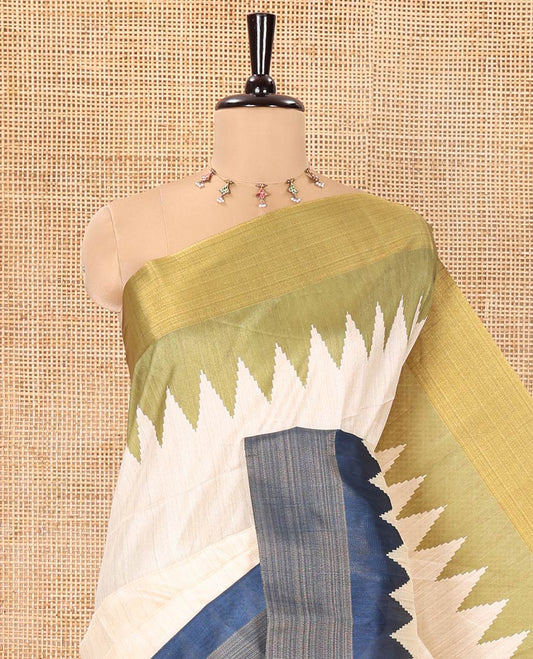 Cream Plain Semi-Jute Tussar Saree, Complemented by a Contrast Green-Blue Ganga-Jamuna Temple Border, Sparsely Striped Pallu, and Paired with a Contrast Blouse