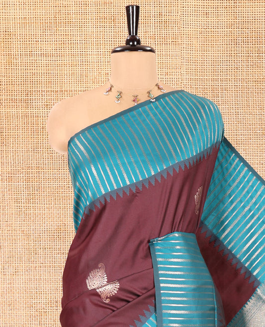 Wine Elite Soft Silk Saree, Elevated with Zari Buttas All Over Its Body, Complemented by Contrast Border Steeped with Geometric Patterns, Grand Pallu, and Paired with a Contrast Blouse