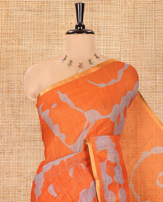 Orange Linen Cotton Saree, Enthralled with Shibori Printed on Its Body, Subtle Piping Border, Pallu of Floral Vine Print, and Paired with a Contrast Floral Vine Printed Blouse