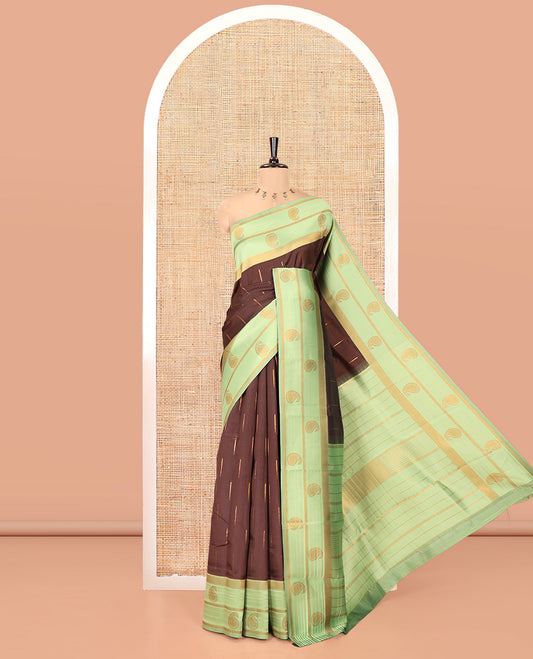 Brown and Green Kanchi Silk Saree, Ornamented with Zari Buttas All Over Its Body, Complemented by a Contrast Border of Paisleys, Zari-Striped Pallu, and Paired with a Contrast Jacquard Blouse