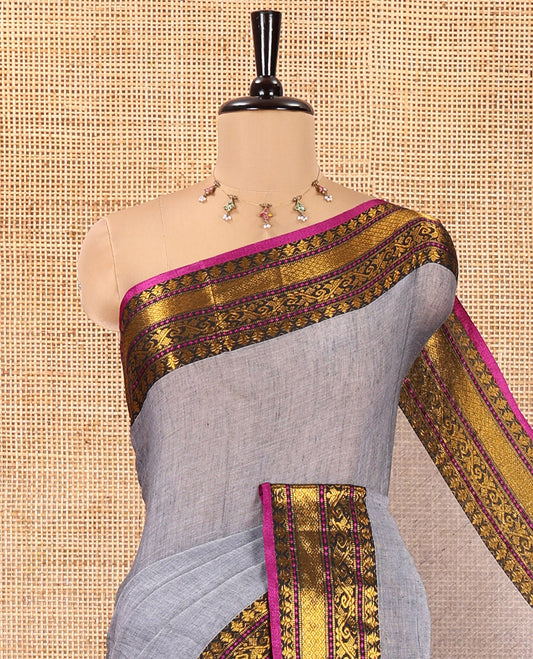 Grey Plain Khadi Mul Cotton Saree, Complemented by a Contrast Traditional Zari Border, a Self-Pallu, and Paired with a Matching Blouse