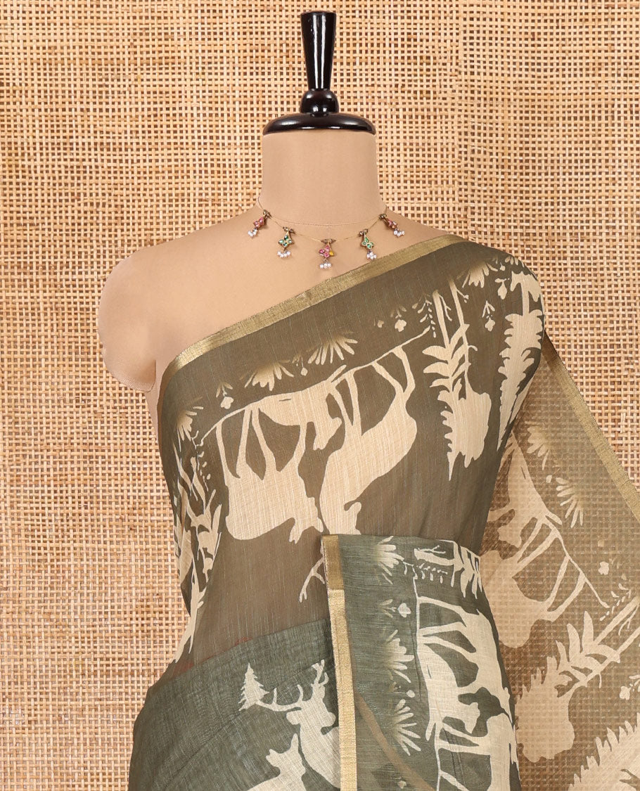 Green Christmas-Themed Linen Cotton Saree, Decorated with Christmas Tree Motifs Printed on Its Body, a Subtle Piping Border, Pallu of Christmas-Themed Print, and Paired with a Contrast Floral Printed Blouse