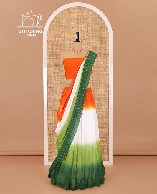 Multi-color half-saree, Indian flag theme ombre-colored viscose georgette skirt, a plain orange blouse, and a tri-colored zari striped dhavani