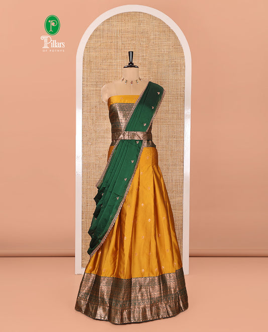 Yellow and Green Semi-Banarasi Half-Saree Adorned with Zari Buttas on Its Skirt, Complemented by a Contrast Mughal-Style Intricate Zari Design Border, Paired with a Matching Blouse, and a Satin Georgette Embroidered Scallop Dhavani