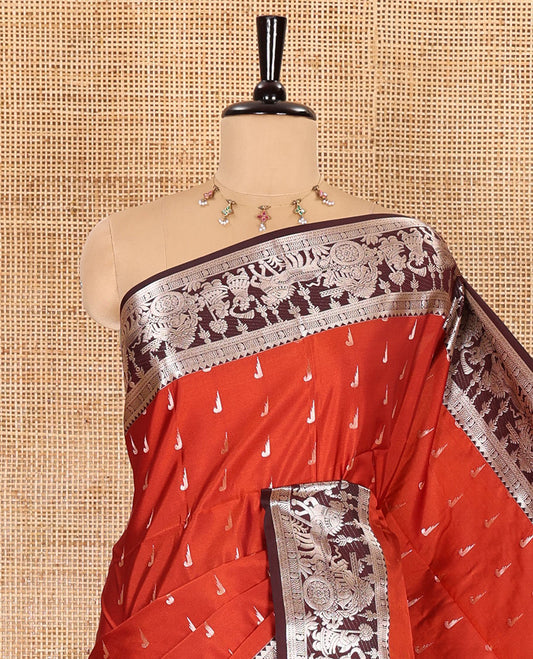 Rust and coffee-brown muniya buttas semi-soft silk saree with a contrasting wedding-theme zari border, zari-rich intricate pallu, and a contrasting zari-bordered blouse