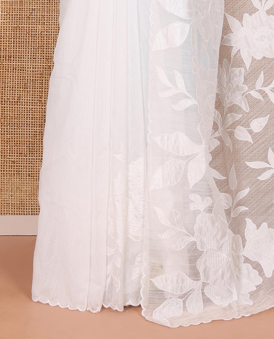 White floral motifs applique embroidered linen saree, scallop border, floral motifs embroidered pallu, and a plain blouse