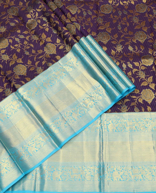 Violet Pure Silk Half-Saree, Gracefully Embellished with Floral Jacquard All Over Its Skirt, Complemented by a Contrast Border of Mayil, Yaanai, Mayil Kann, and Jaal Designs, Paired with a Contrast Blouse, and Comes with a Zari Design Dhavani