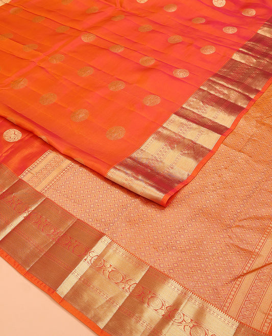 Orange Vasundhara Lite Silk Mix Saree, Showcasing Zari Buttas on Its Body, Highlighted by Zari Border of Rekku, Muthu, Rudraksham, Mayil Kann, and Chakram Designs, Grand Jaal Pallu, and Paired with a Matching Blouse