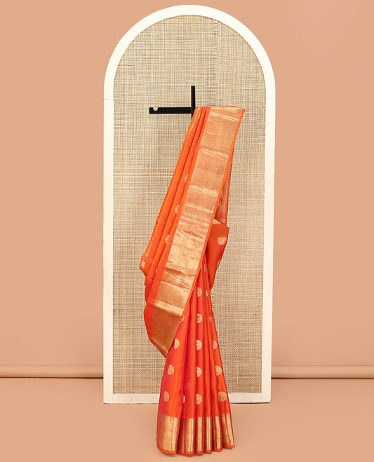 Orange Vasundhara Lite Silk Mix Saree, Showcasing Zari Buttas on Its Body, Highlighted by Zari Border of Rekku, Muthu, Rudraksham, Mayil Kann, and Chakram Designs, Grand Jaal Pallu, and Paired with a Matching Blouse