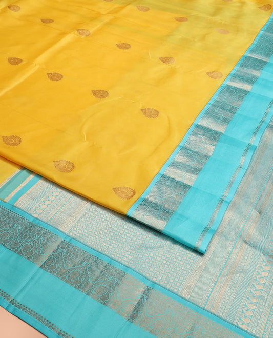 Yellow Vasundhara Silk Saree Embellished with Zari Buttas, Complemented by a Contrast Rettai Pettu Border of Salngai, Neli, Kathir, Mayil, and Kathir Designs, Featuring a Pallu of Jaal Designs, and a Contrast Blouse