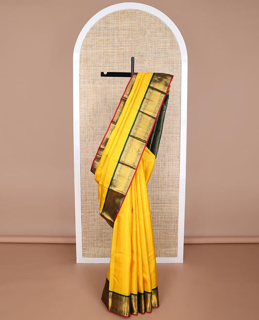 Yellow floral buttas silk saree with contrast border of thilakam mokku, paun, banaras, poo chakram design & zari design pallu