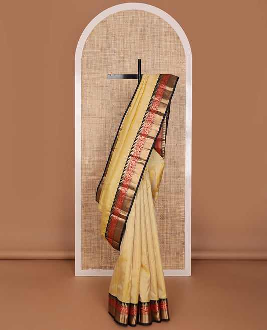 Yellow buttas silksaree,contrast thilakam butta enclosed checked pallu & border of rekku,kathir,stripes & kodi visiry