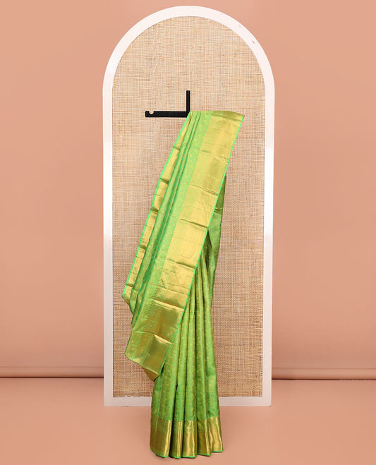 Green Kanchipuram Wedding Silk Saree, Artfully Detailed with Jacquard Designs on Its Body, Highlighted by a Zari Border of Thilakam, Rettai Neli, and Kodi Visiry Designs, Gracefully Embellished Pallu, and Paired with a Matching Blouse