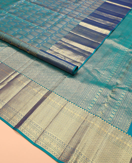 Blue jacquard kanchipuram silk saree, zari border of thilakam mokku, neli, kodi visiry, jada nagam, and jaal designs, and jaal pallu
