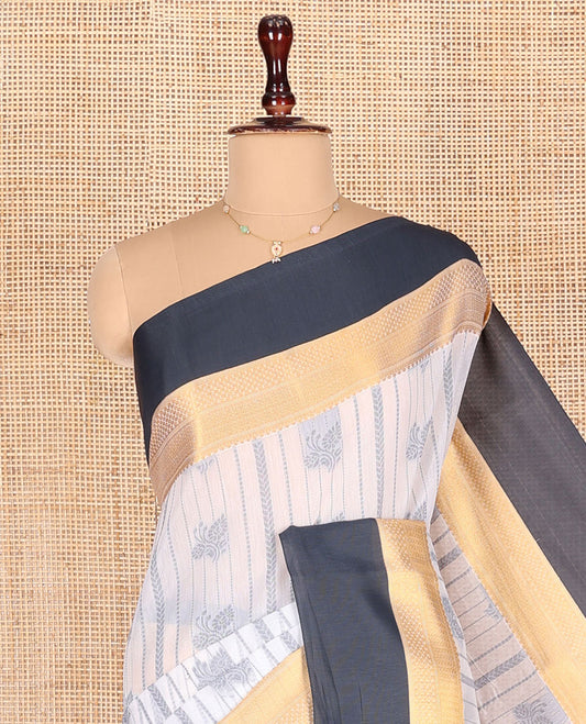 Grey Semi-Silk Cotton Saree, Embellished with Buttas and Stripes All Over Its Body, Complemented by a Contrast Traditional Zari Design Border, Pallu of Jaal Designs, and Paired with a Matching Blouse