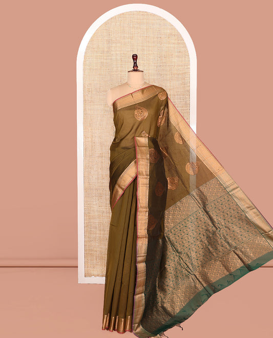 Green Semi-Silk Cotton Saree, Gleamed Up with Zari Buttas on Its Body, Complemented by Contrast Traditional Zari Border, Grand Pallu of Scallop Designs, and Paired with a Contrast Blouse