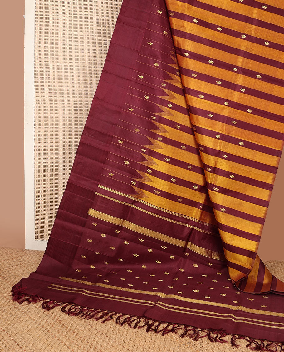 Maroon & yellow striped Kanchipuram silksaree with zari buttas, one-sided temple border & zari woven pallu