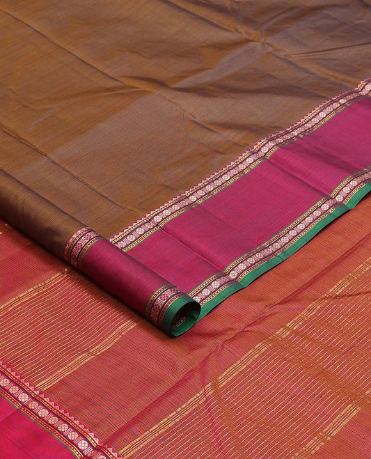 Brown plain Kanchipuram silk saree, contrast border of rekku, muthu, rudraksham, and mayil designs, and zari striped pallu