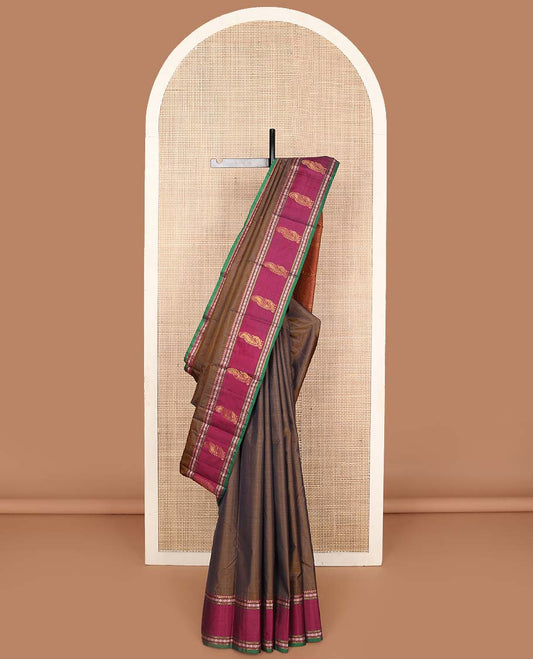 Brown plain Kanchipuram silk saree, contrast border of rekku, muthu, rudraksham, and mayil designs, and zari striped pallu