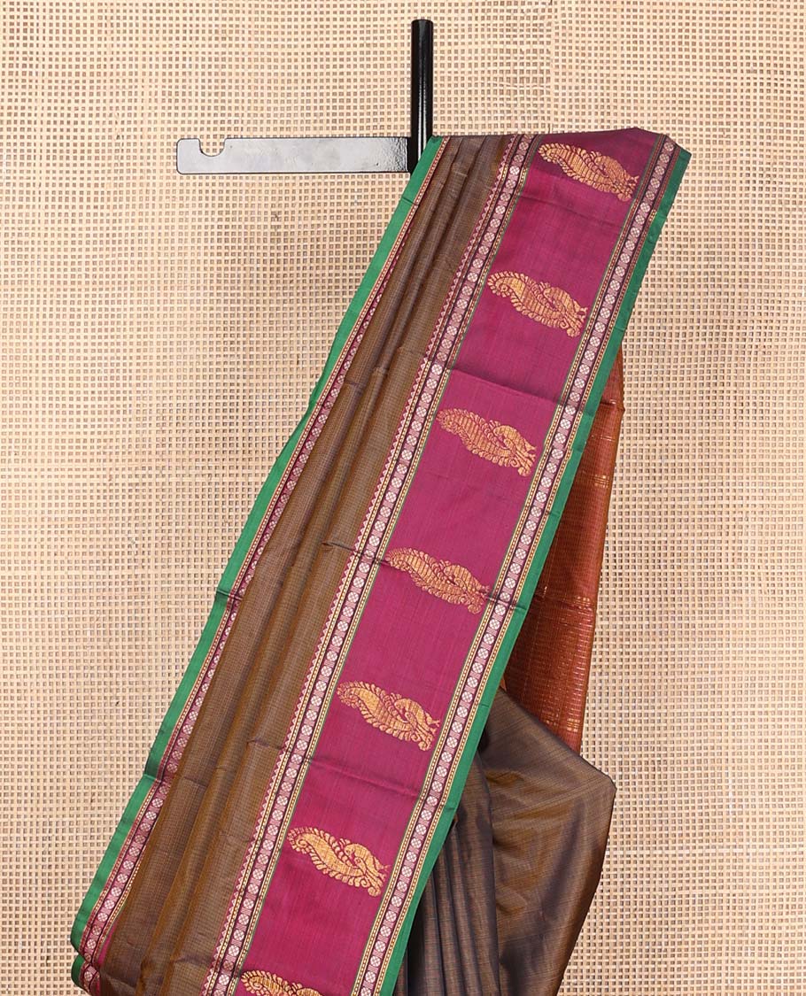 Brown plain Kanchipuram silk saree, contrast border of rekku, muthu, rudraksham, and mayil designs, and zari striped pallu