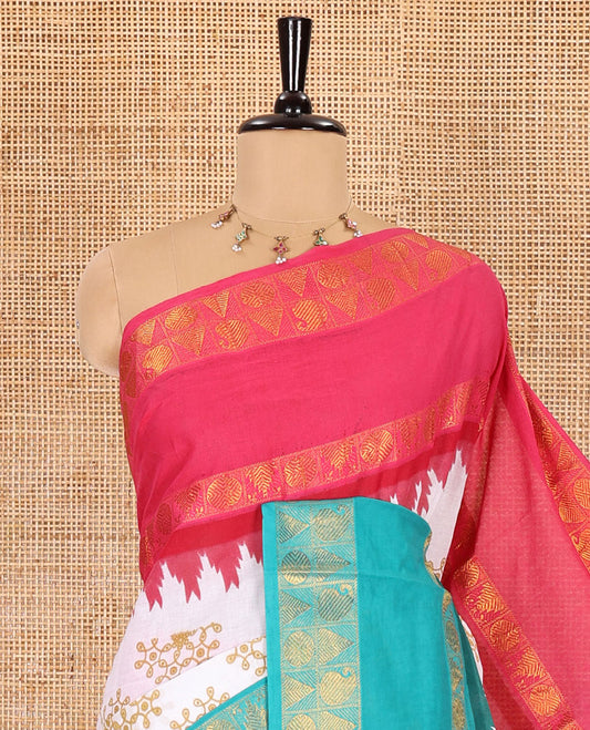 White kolam motifs printed Sungudi cotton saree, contrast pink-blue ganga jamuna rettai pettu traditional zari border, floral motifs pallu, and a contrast elephant motifs blouse