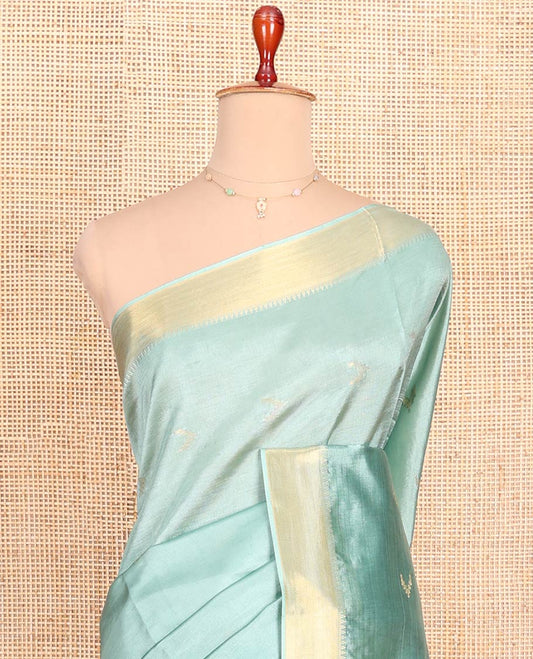 Pale Green Banana Pith Saree Decorated with Zari Temple Buttas, Delicately Woven Temple Zari Border, Gleaming Zari Pallu of Horizontal Stripes in Zari, and Paired with a Matching Plain Blouse