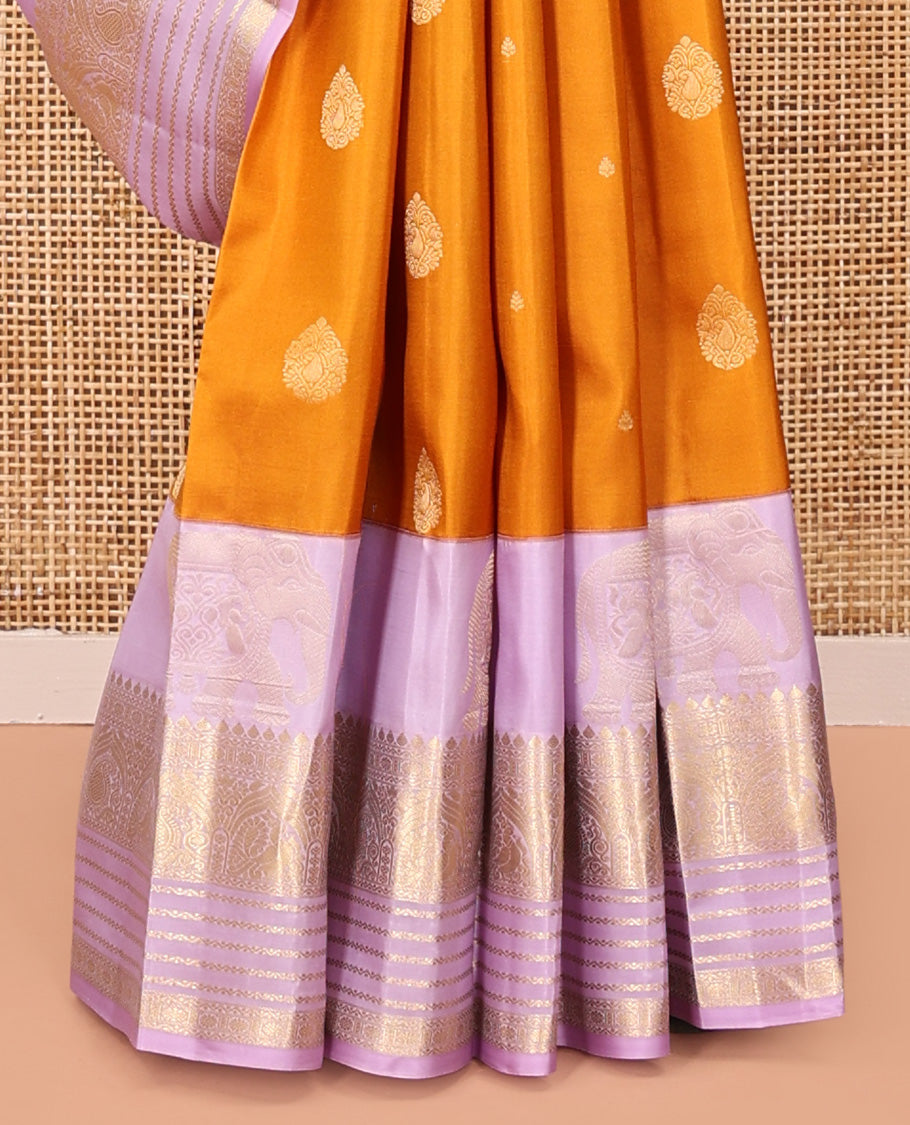 Orange Vasundhara Silk Saree, Decked Up with Zari Buttas All Over Its Body, Complemented by a Contrast Border of Yaanai, Thilakam, Neli, Kamalam, Mayil, and Manga Designs, Grand Jaal Pallu, and Paired with a Contrast Blouse