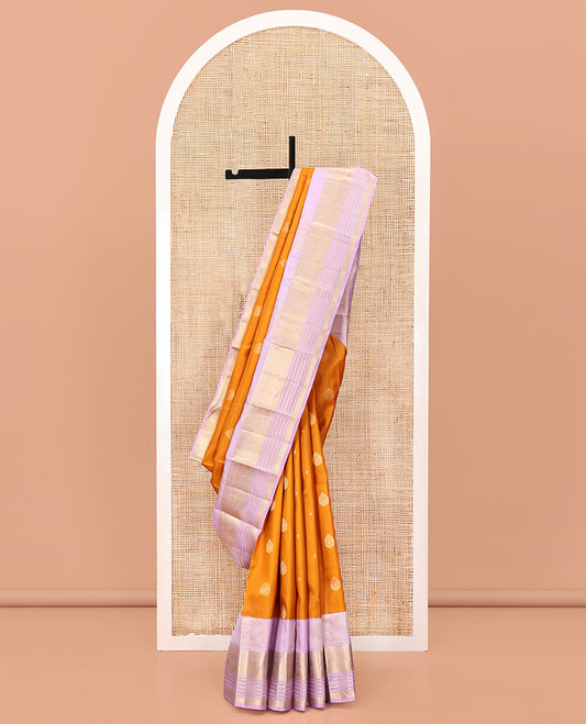 Orange Vasundhara Silk Saree, Decked Up with Zari Buttas All Over Its Body, Complemented by a Contrast Border of Yaanai, Thilakam, Neli, Kamalam, Mayil, and Manga Designs, Grand Jaal Pallu, and Paired with a Contrast Blouse