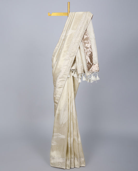 Cream dola silk saree with feather buttas, gleaming border & pallu of intricate designs